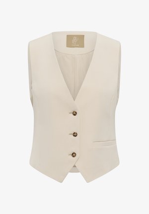 Krēmkrāsas bezroku veste ar V veida izgriezumu, trim brūnām pogām un mazu kabatu apakšējā labajā pusē.