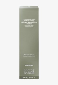 Boîte rectangulaire verte pour un tonique, étiquetée « Tonique Équilibrant aux Plantes » avec un texte argenté détaillant les ingrédients et le volume.