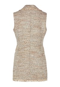 Ärmlös väst i ett vävt mönster, med en ljusbeige och brun färgpalett. Fransiga kanter vid halsringningen och nederkanten ger en detalj.