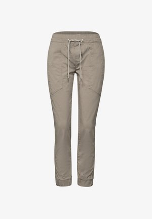 Beżowe dresy z elastycznym pasem i sznurkiem, z bocznymi kieszeniami i zwężanymi nogawkami. Wykonane z miękkiego, lekkiego materiału.