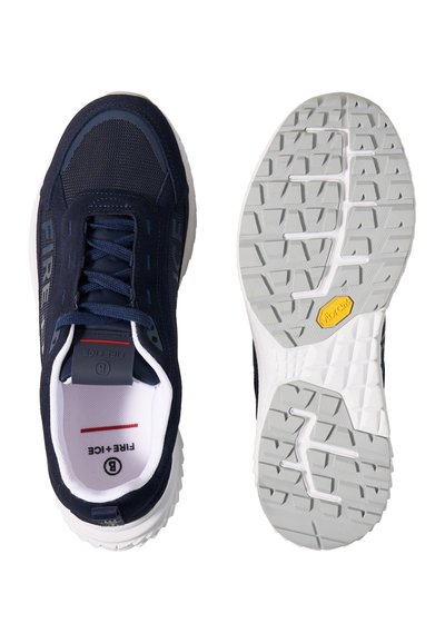 Navy blue sneaker with mesh and suede upper, white inner lining, laces, and textured grey sole showing Vibram logo.