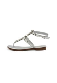 Sandali argento con profilo slim, design a T, gemme decorative trasparenti e suola piatta marrone. Soletta testurizzata per comfort.