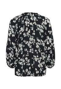 Schwarze Bluse mit floralen Motiven, die weiße Blumen zeigt, langen Puffärmeln und einem gerafften Ausschnitt. Leichter Stoff mit entspanntem Schnitt.