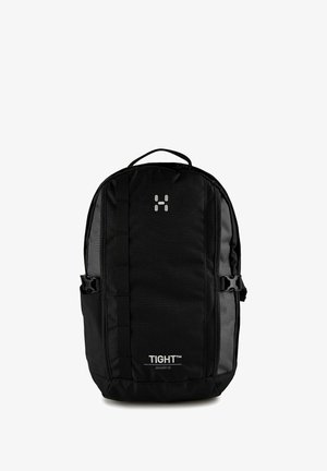 Zaino compatto nero con tasche laterali, manico superiore, spallacci regolabili e marchio "TIGHT Junior 15" sulla pannello frontale.