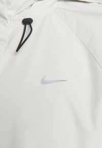 Nike Performance STORM-FIT SWIFT - Running jacket - pale ivory/black/silver