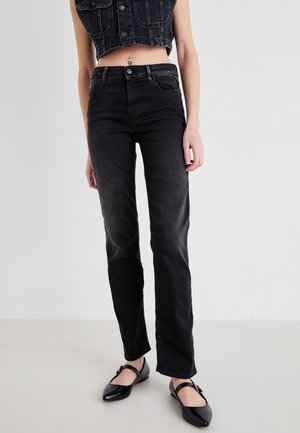 Black denim high-waisted jeans with a straight leg design. Features subtle fading and classic five-pocket styling. Paired with black flats.