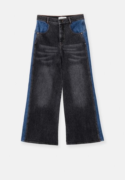 Jean large avec de la denim gris foncé et des panneaux latéraux bleus. Détails déchirés sur le devant, fermeture par bouton et poches standard.