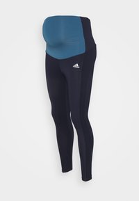 Legginsy ciążowe zaprojektowane z myślą o komforcie, z niebieskim pasem, ciemnonawigacyjnych nogawkach, dopasowanym kroju i logo Adidasa na dolnej części nogi.
