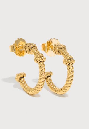 Gold twisted rope-texture hoop earrings with butterfly backings on a light background.