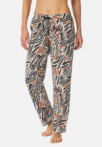 Losse pyjamabroek in beige met een gedurfde abstracte print van zwarte en roestkleurige streken. Heeft een elastische tailleband en zakken.