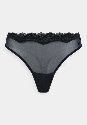 Zwarte stringonderbroek gemaakt van doorschijnende stof met een delicate kanten tailleband. Kenmerkt zich door een zachte textuur en een minimalistisch ontwerp.