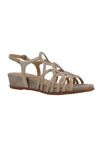Sandalias de cuña beige con un diseño de tiras y acentos brillantes, punta abierta y suela texturizada para mayor agarre.