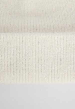 Tissu en laine tricoté côtelé de couleur blanc cassé. La texture est douce, avec des fibres visibles et un bord solide et flexible en bas.