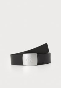 Čierny kožený opasok s obdĺžnikovou striebornou kovovou sponou s vygravírovaným logom "CK". Hladká textúra a elegantný dizajn.
