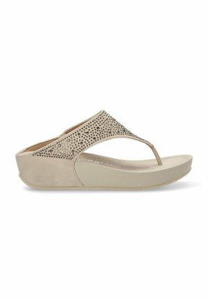 Sandalia beige con una correa de textura suave adornada con pequeños strass. Suela plana con una ligera cuña para mayor comodidad y soporte.