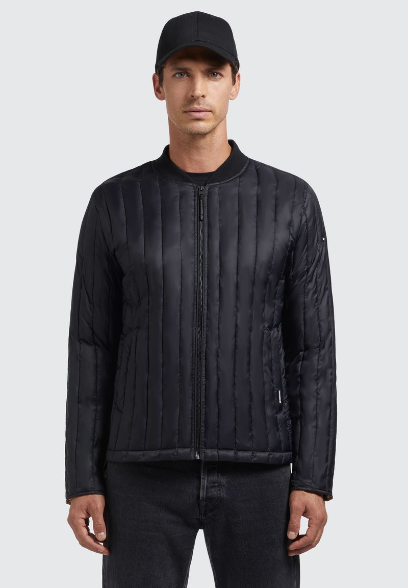 Black quilted bomber jacket with a front zipper, ribbed collar, and long sleeves. Features a smooth texture and vertical stitching details.