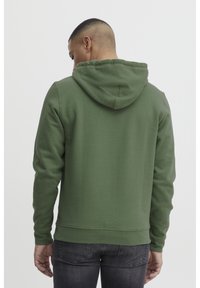 Green hooded sweatshirt with a soft texture, ribbed cuffs, and waistband. Features a kangaroo pocket and flat drawstring in the hood.