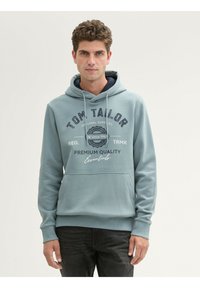 Felpa leggera blu con tasca a canguro, cappuccio con coulisse e fodera blu navy. Presenta testo grafico anteriore e polsini e orlo a coste.