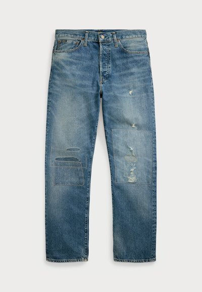Light blue denim jeans with a straight leg design. Features distressed areas and patch details on both legs. Traditional five-pocket styling.