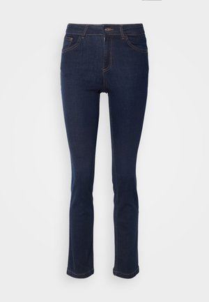 Denim jeans in dark blue with a slim fit, mid-rise waist, five pockets, and contrast stitching. Fabric has a smooth, slightly textured finish.