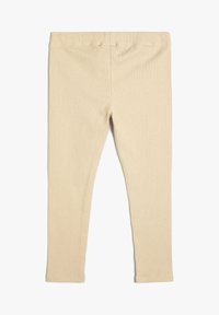 Beżowe legginsy w prążki z miękką teksturą i elastycznym paskiem na talii, zaprojektowane z myślą o komforcie i swobodzie ruchów, o fasonie slim fit.