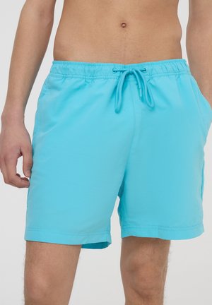 Pantaloni da bagno color acquamarina con vita elastica e cordoncino. Presentano tasche laterali e un tessuto leggero e liscio. Vestibilità regolare.