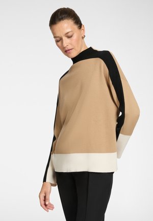 Brown, black, and cream color-blocked knit sweater with a high neck and wide sleeves, featuring a soft texture. Subtle pattern detail at edges.