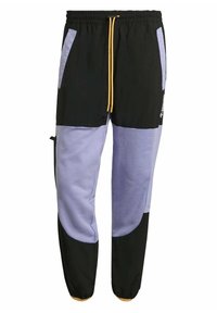 Färgblockerade träningsbyxor i svart och ljuslila, med resårmidja, gul dragsko och sidofickor med dragkedja.