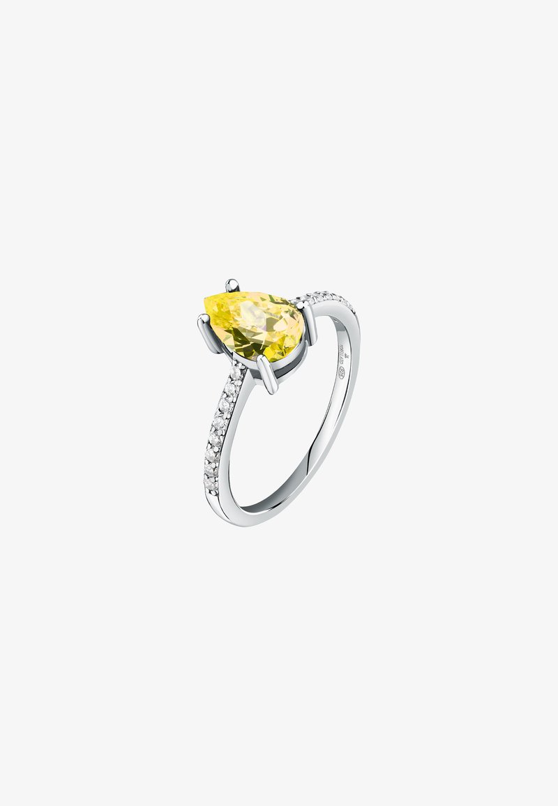Anello in metallo bianco con una pietra gialla a forma di pera, decorato con piccole pietre trasparenti lungo la fascia per un tocco di brillantezza in più.