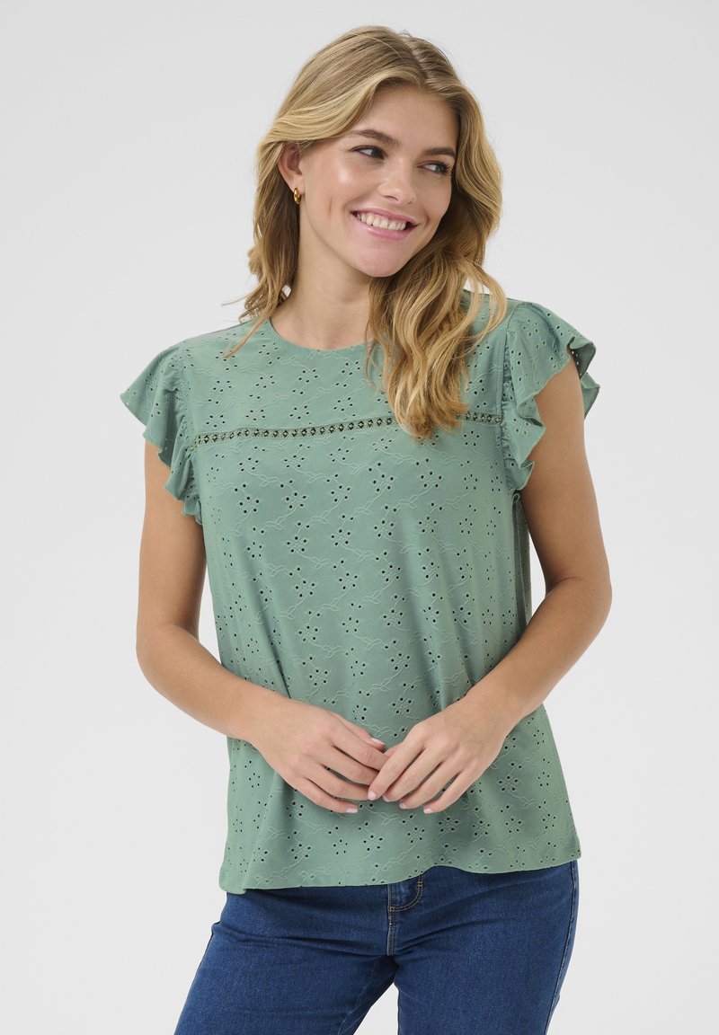 Top verde a maniche corte con maniche arricciate, in tessuto ad occhio di pernice, con delicati motivi ricamati e una vestibilità comoda.