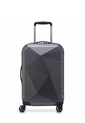 Dark gray hard-shell suitcase with geometric pattern, four spinner wheels, telescopic handle, and side handle, branded "Delsey Paris."