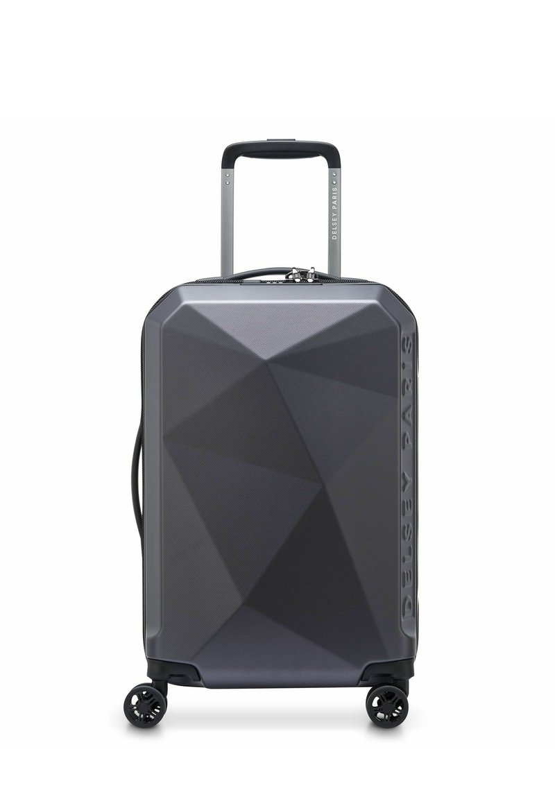 Dark gray hard-shell suitcase with geometric pattern, four spinner wheels, telescopic handle, and side handle, branded "Delsey Paris."