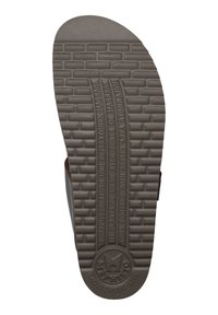 Semelle de sandale en caoutchouc brun avec un motif texturé ressemblant à des briques, présentant un texte en relief et un logo au niveau du talon.