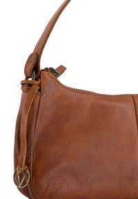 Brown leather handbag with a textured surface, zipper closure, and an adjustable strap featuring a metal accent near the base.