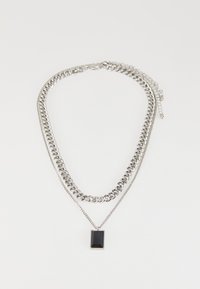Silver multi-layered necklace with varying chain styles, featuring a rectangular black pendant on the shortest chain.