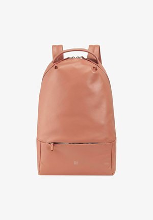 Peach-colored leather backpack with a smooth texture, rounded shape, two shoulder straps, and a front zip pocket. Features brand logo in silver.