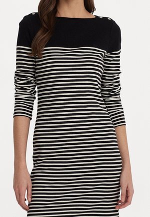 Robe à rayures noires et blanches avec des manches longues, décolleté rond et détails en boutons sur l'épaule, fabriquée en tissu doux.