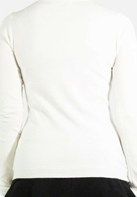 Pull blanc à manches longues avec un design ajusté, texture lisse et ourlet côtelé, sans motifs ni détails matériels supplémentaires.