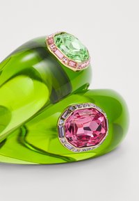 Green translucent bangle featuring prominent pink and green faceted gemstones, set in gold accents, with additional smaller gem details.