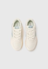 White athletic sneakers with a mesh upper and light blue accents. Laces are woven; cushioned interior and rubber sole. Simple design.