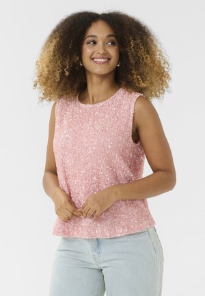 Pink sleeveless top made of sequined fabric with a round neckline. Soft texture and casual fit, paired with light blue jeans.