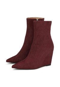 Burgundy wedge ankle boots with a pointed toe, crafted from soft, textured material, featuring a sleek, minimalist design and a side zipper.