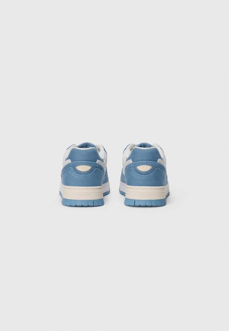 Blå och vita sneakers med ett strukturerat tygöverdrag, vadderad krage och gummisula. Bakifrån visar den ett distinkt mönster och sula.