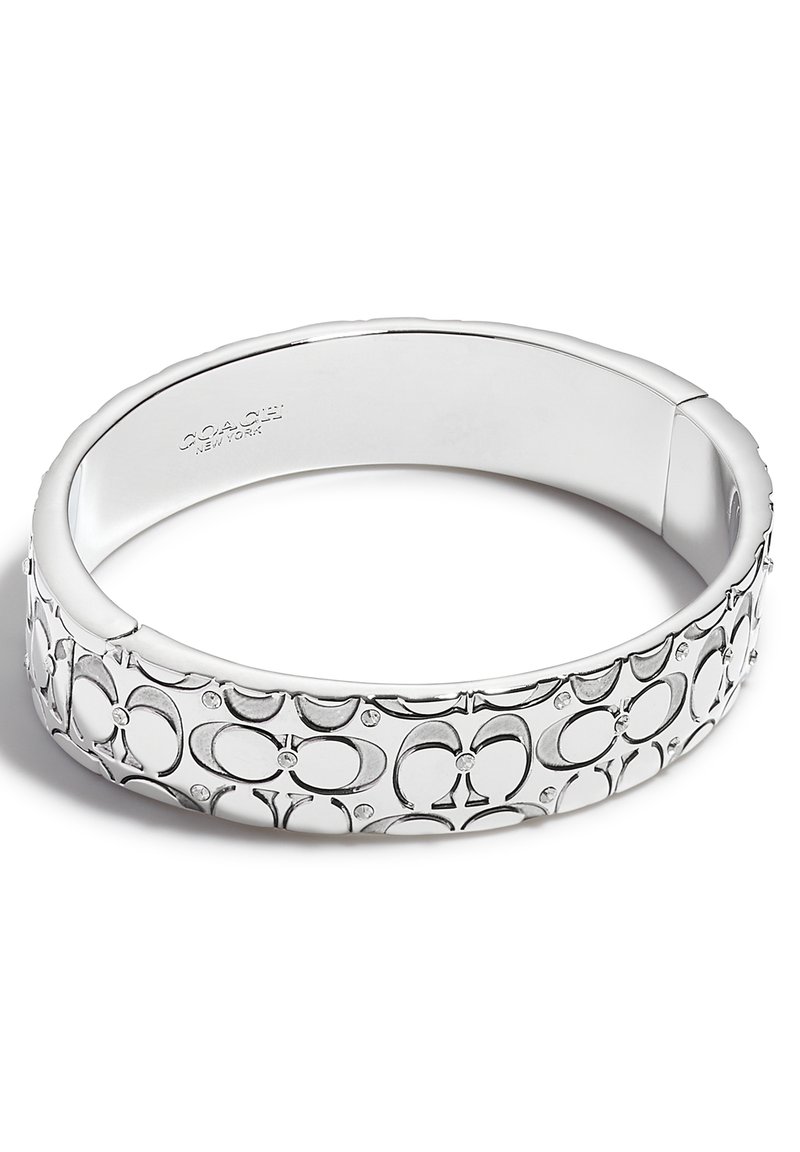 Bracciale in argento con un design a motivo che presenta forme ovali interconnesse e piccole pietre decorative, finitura interna liscia.