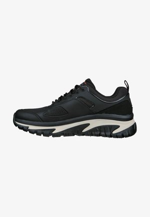 Schwarz sportlicher Schuh mit strukturiertem Obermaterial, Schnürung vorne und gepolsteter Sohle, die einen weißen Akzent entlang der Zwischensohle und ein starkes Profilmuster aufweist.