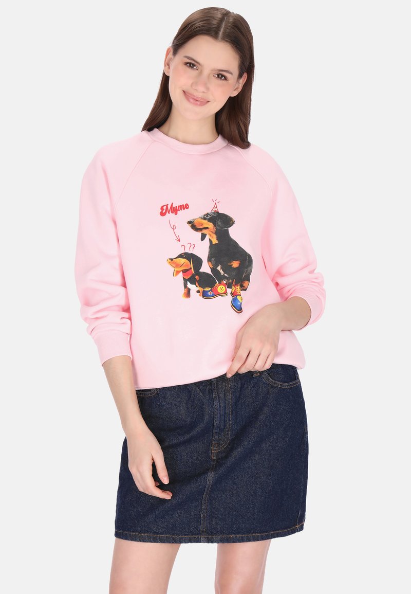 Roze sweatshirt met cartoon teckels en grafische accenten, gecombineerd met een donker denim rokje. Losse pasvorm met geribbelde boorden.
