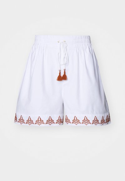 White cotton shorts with an elastic waistband, drawstring, and brown embroidered pattern along the hem. Finished with brown tassel accents.