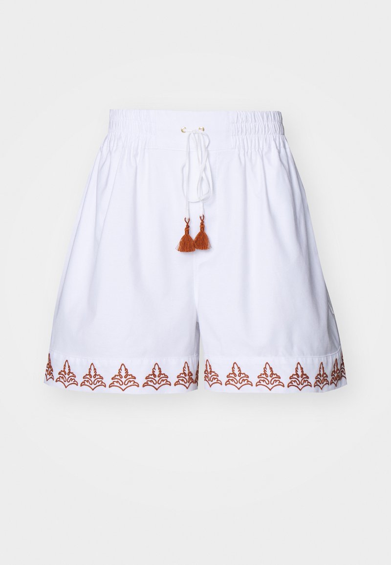 White cotton shorts with an elastic waistband, drawstring, and brown embroidered pattern along the hem. Finished with brown tassel accents.