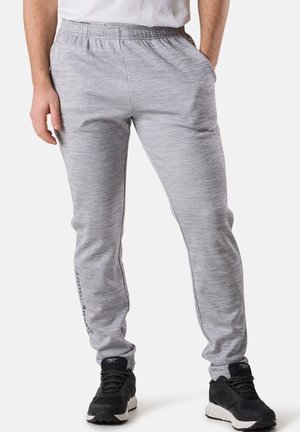 Gray sweatpants with an elastic waistband, side pockets, and a tapered leg design. Features subtle heather texture and branding on the left leg.
