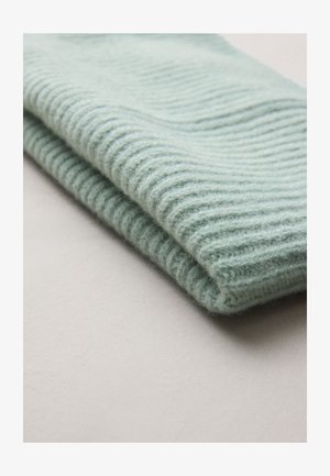 heleroheline soonikuga kootud kangas, mis on pehme tekstuuriga, näitab õrnaid paksuse erinevusi ja veidi läiget.